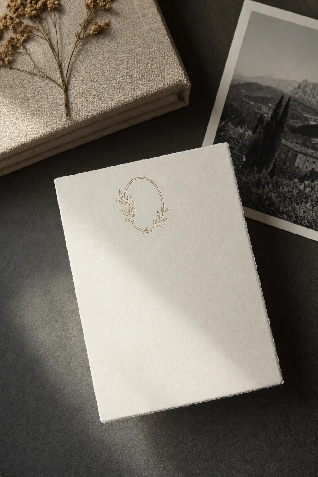 A printed invitation and a small souvenir on linen, soft daylight.